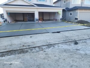 Large concrete driveway over 1,000 square feet with broom finish, installed by Vancal Concrete LTD in Calgary, Alberta.
