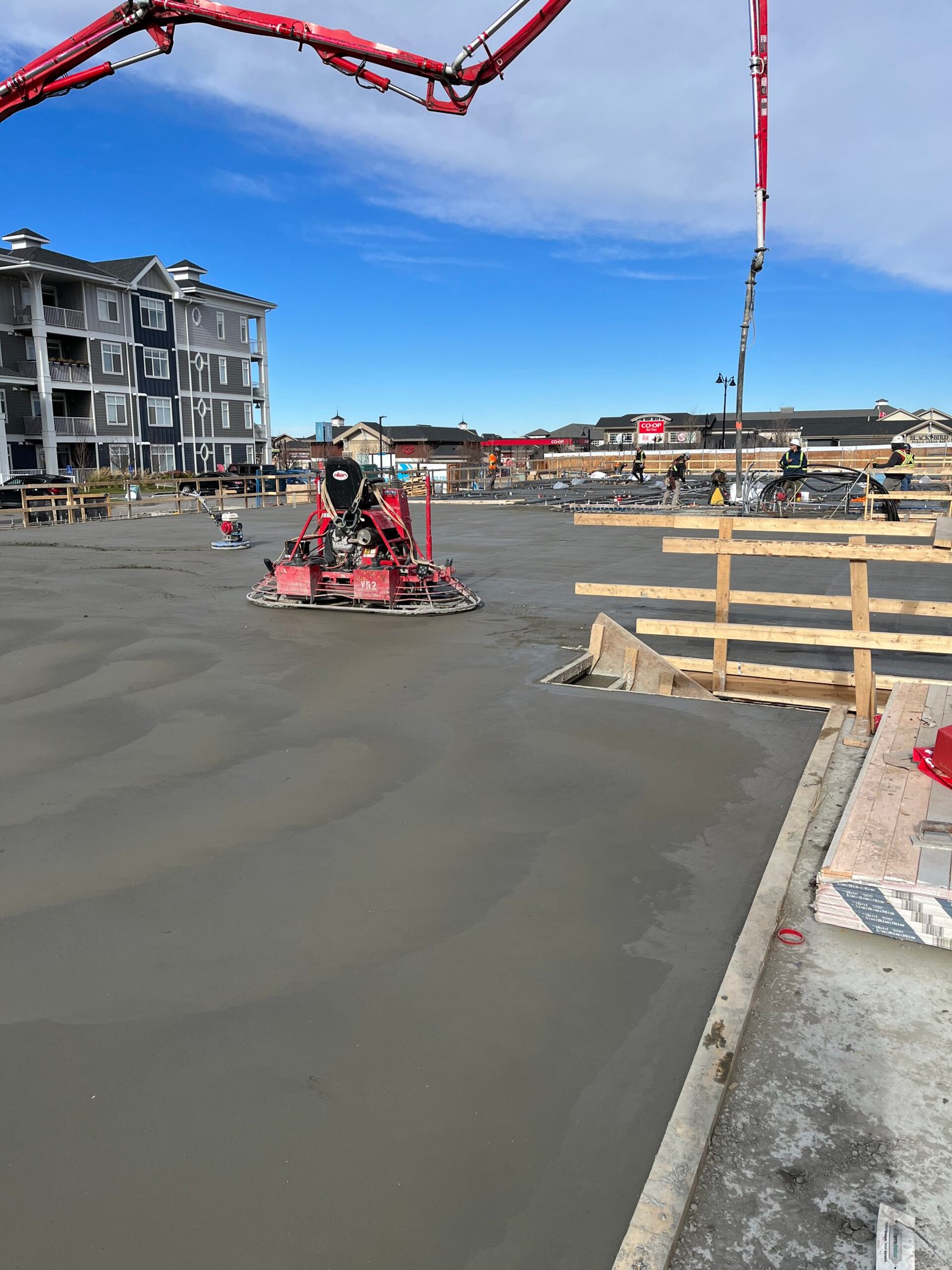 Freshly poured commercial concrete slab on an industrial job site in Calgary