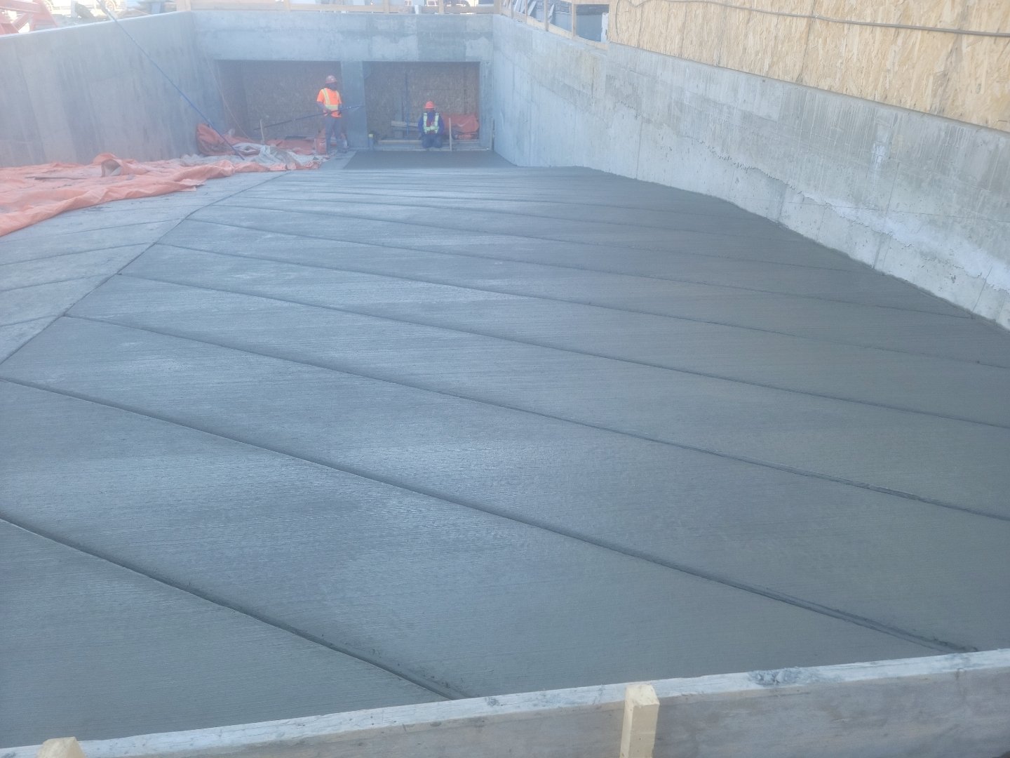 Commercial concrete ramp with diagonal broom finish, constructed by Vancal Concrete LTD in Calgary, Alberta.