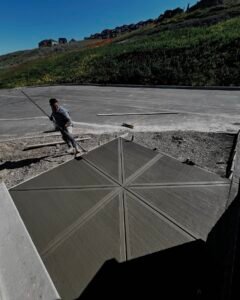 Star-patterned concrete finish with broom texture on a sloped driveway in Calgary
